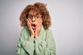 Young beautiful african american woman wearing turtleneck sweater and glasses afraid and shocked, surprise and amazed expression Royalty Free Stock Photo