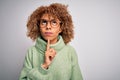 Young beautiful african american woman wearing turtleneck sweater and glasses Thinking concentrated about doubt with finger on Royalty Free Stock Photo