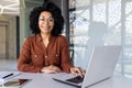 Young beautiful african american woman working inside modern office, businesswoman smiling and looking at camera at work Royalty Free Stock Photo