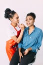 Young beautiful African American woman applying professional make-up by African make-up artist. Studio shoot Royalty Free Stock Photo