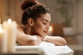 Beautiful african girl resting relaxing in spa resort with closed eyes.