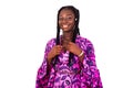 Young beautiful african woman standing against white background showing her braided hair laughing Royalty Free Stock Photo