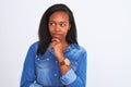 Young beautiful african woman wearing casual denim shirt over isolated white background serious face thinking about question, very Royalty Free Stock Photo