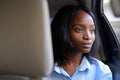 Young beautiful African Zulu businesswoman riding inside the car