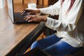 Young beautiful Afro-American businesswoman using laptop while working in cafe Royalty Free Stock Photo