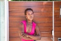 Young and beautiful Afro American woman doing different postures and expressions on a wooden background. The woman is smiling, sad Royalty Free Stock Photo