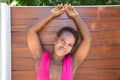 Young and beautiful Afro American woman doing different postures and expressions on a wooden background. The woman is smiling, sad Royalty Free Stock Photo