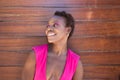 Young and beautiful Afro American woman doing different postures and expressions on a wooden background. The woman is smiling, sad Royalty Free Stock Photo