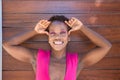 Young and beautiful Afro American woman doing different postures and expressions on a wooden background. The woman is smiling, sad Royalty Free Stock Photo