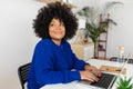 Young beautiful afro american woman working on laptop at home Royalty Free Stock Photo