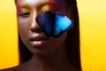 Young beautiful afro girl, vivid image with blue butterfly Royalty Free Stock Photo