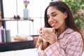 Young beautiful arab woman drinking cup of coffee sitting on bed at bedroom Royalty Free Stock Photo