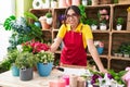 Young beautiful arab woman florist smiling confident standing at flower shop Royalty Free Stock Photo