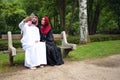 Young beautiful Arabian couple casual and hijab, Abaya, taking a selfie on the lawn in summer park.