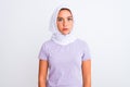 Young beautiful arabian girl wearing hijab standing over isolated white background Relaxed with serious expression on face