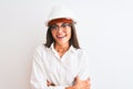 Young beautiful architect woman wearing helmet and glasses over isolated white background happy face smiling with crossed arms Royalty Free Stock Photo