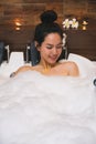 Young beautiful asia woman takes bubble bath