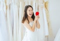 Young beautiful asian bride female in white dress with hands holding model heart red color,Happy and smiling Royalty Free Stock Photo