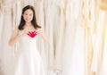 Young beautiful asian bride women in white dress with hand holding model heart red color,Happy and smiling Royalty Free Stock Photo