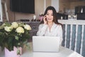 Young Beautiful Asian business woman working online with laptop computer placed at the table at home office. Smiling Royalty Free Stock Photo