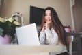 Young Beautiful Asian business woman working online with laptop computer placed at the table at home office. Smiling Royalty Free Stock Photo