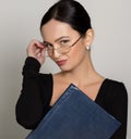 Young beautiful Asian businesswoman wearing eyeglasses with folder for papers Royalty Free Stock Photo