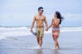 young beautiful Asian Chinese couple walking together on the beach happy in love enjoying holidays and relax smiling joyful in Royalty Free Stock Photo