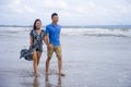 young beautiful Asian Chinese couple walking together on the beach happy in love enjoying holidays and relax smiling joyful in Royalty Free Stock Photo