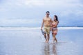 young beautiful Asian Chinese couple walking together on the beach happy in love enjoying holidays and relax smiling joyful in Royalty Free Stock Photo