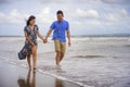 young beautiful Asian Chinese couple walking together on the beach happy in love enjoying holidays and relax smiling joyful in Royalty Free Stock Photo