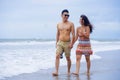 young beautiful Asian Chinese couple walking together holding hands on the beach happy in love Royalty Free Stock Photo