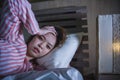 Young beautiful Asian Chinese girl lying on bed late night awake looking thoughtful suffering insomnia sleeping disorder feeling Royalty Free Stock Photo