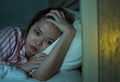 Young beautiful Asian Chinese girl lying on bed late night awake looking thoughtful suffering insomnia sleeping disorder feeling Royalty Free Stock Photo