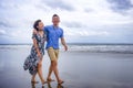 young beautiful and Asian Chinese romantic couple walking together embracing on the beach happy in love enjoying holidays Royalty Free Stock Photo