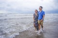 young beautiful and Asian Chinese romantic couple walking together embracing on the beach happy in love enjoying holidays Royalty Free Stock Photo
