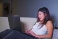 Young beautiful Asian Chinese student girl happy and relaxed at home couch using internet on laptop computer networking cheerful i Royalty Free Stock Photo