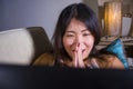 Young beautiful Asian Chinese student girl happy and relaxed at home sofa couch using internet on laptop computer networking cheer Royalty Free Stock Photo