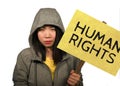 Young beautiful Asian Chinese student woman as protestor and pacifist holding protest billboard with human rights text against