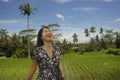 Young beautiful Asian Chinese tourist exploring jungle and rice field pad area in Bali Indonesia relaxed and happy enjoying holida