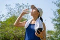 Young beautiful asian drinking water after jogging running outdoor. Sport healthy running concept Royalty Free Stock Photo
