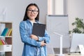 Young beautiful Asian female teacher looking at the camera and smiling, portrait of a woman in the office Royalty Free Stock Photo