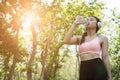 young beautiful asian fitness athlete woman drinking water after Royalty Free Stock Photo