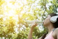 young beautiful asian fitness athlete woman drinking water after Royalty Free Stock Photo