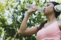 young beautiful asian fitness athlete woman drinking water after Royalty Free Stock Photo