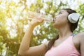 young beautiful asian fitness athlete woman drinking water after Royalty Free Stock Photo