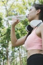 young beautiful asian fitness athlete woman drinking water after Royalty Free Stock Photo