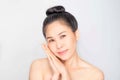 Young beautiful asian girl with clean skin, Cosmetic Beauty Concept,hands touch on the cheek, smiling and friendly face isolated o Royalty Free Stock Photo