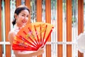 Young Beautiful Asian Girl with Qipao, Happy and Smiley Friendly in Chinese New Year Festival in Thailand.