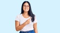 Young beautiful asian girl wearing casual clothes and glasses cheerful with a smile on face pointing with hand and finger up to Royalty Free Stock Photo