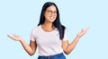 Young beautiful asian girl wearing casual clothes and glasses smiling showing both hands open palms, presenting and advertising Royalty Free Stock Photo